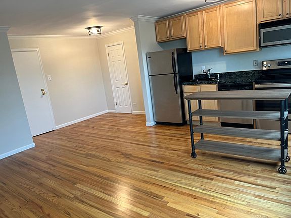 Dining room under light fixture with walk in pantry behind