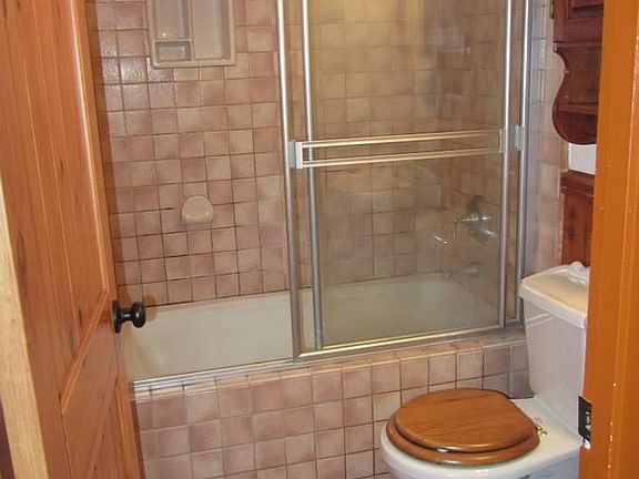 Tiled bathroom with shower and bath.