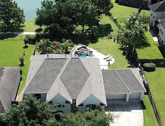 Beautiful home on the lake, 3 car garage, pool, slide, grotto, gated neighborhood, etc!