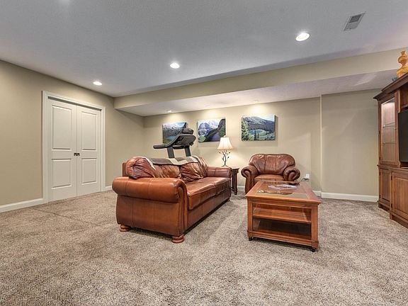 Downstairs media room with plenty of storage behind pocket doors