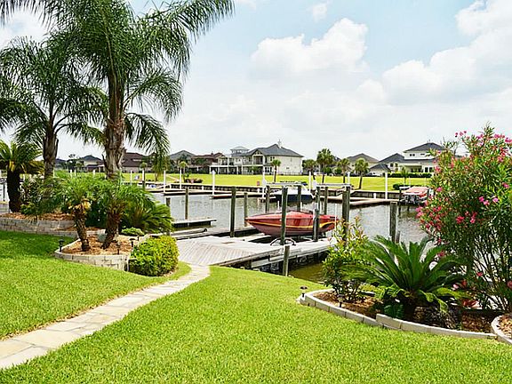 View of landscaped yard by water.