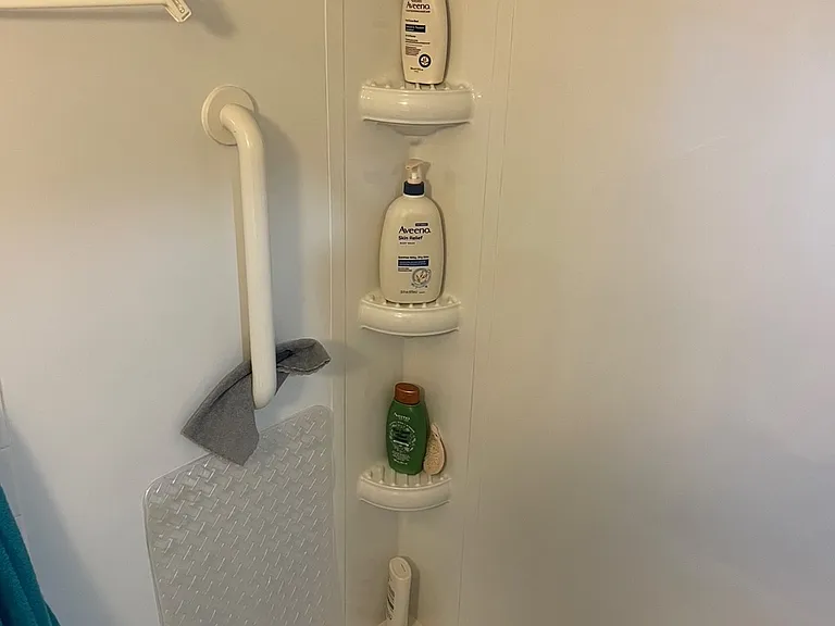 Bathroom tub/shower equipped with safety bar.