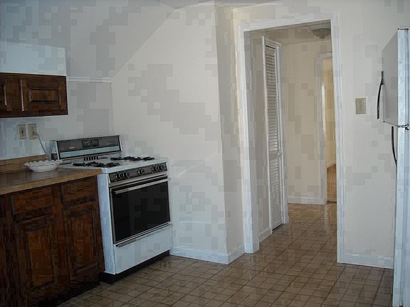 View of hall from the kitchen. Hall leads to living room, ba
