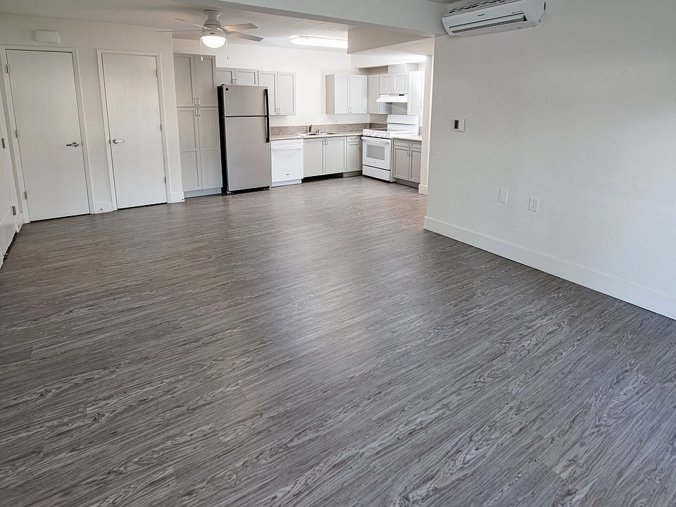 Spacious living area with modern flooring.