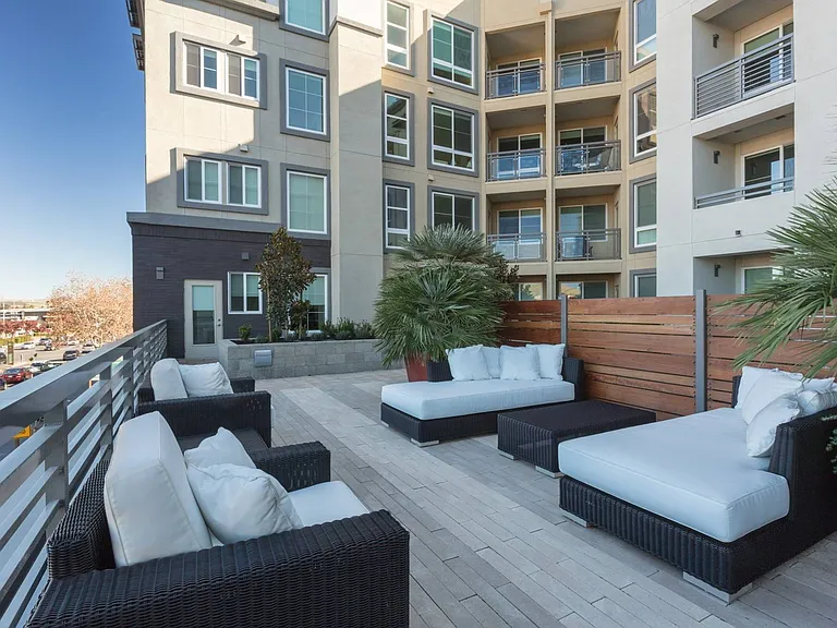 Outdoor sitting area with modern furniture and fire features at Aster Apartments in Dublin, CA.