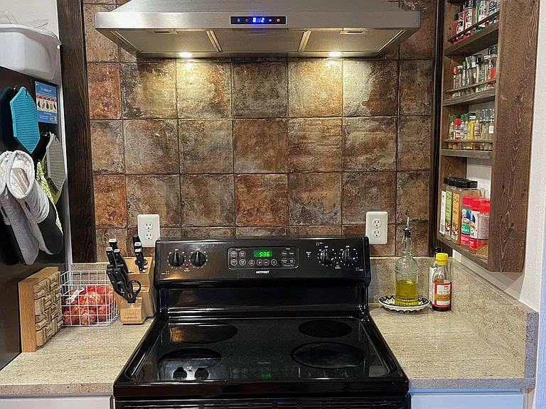 New range hood, tile backsplash, granite, GFCI outlets, soft-close cabinets.