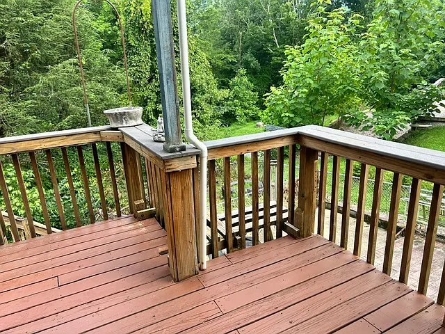 Spacious back deck with woodsy views