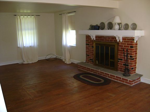 Huge living room with wood-burning fireplace.