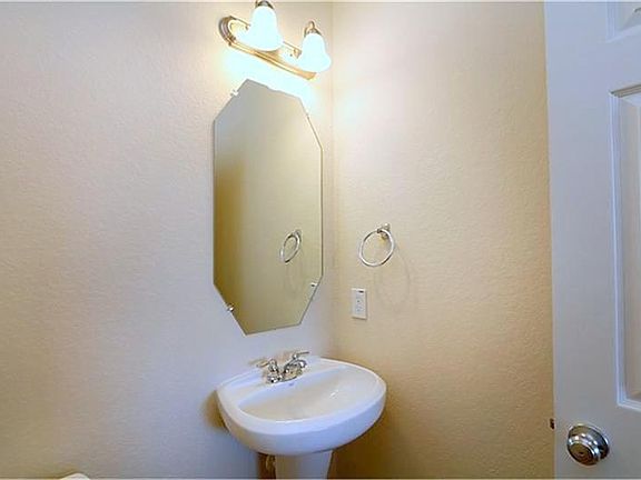 Half bathroom on 1st floor with tiles.