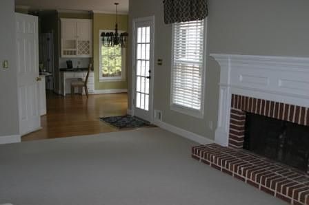 Brick Fireplace in den looking to kitchen.