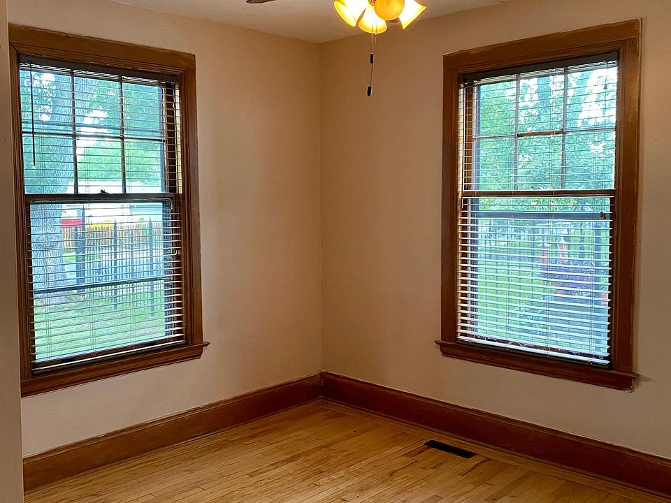 The main floor bedroom is spacious with a nice sized closet, hardwood floors, wood blinds and a ceiling fan.