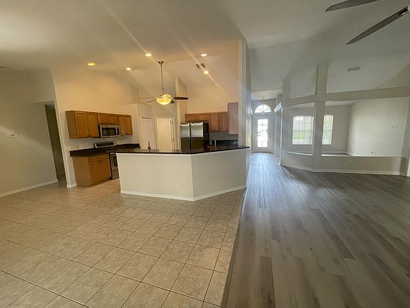 very open floor plan- seen here living room, dining room, kitchen, front door and bonus area