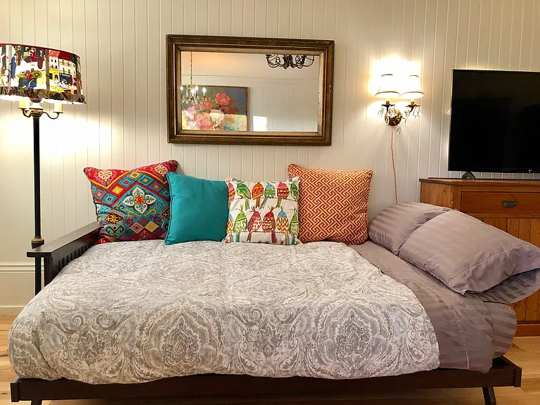Futon couch turned into cozy bed. We know the importance of a good night's sleep! Two additional guests will enjoy our futon bed with high-quality padded innerspring mattress.