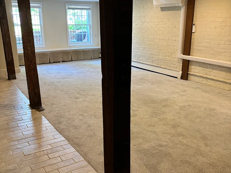 View of LR from brown wooden storage doors.