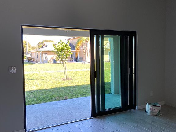 Indoor/outdoor space created by sliding patio door from 3 panels in to 1
