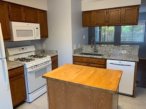 Kitchen with butcher block island and granite countertops