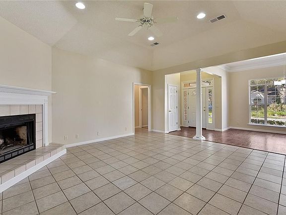 Living Room offers tile floors with wood burning fireplace.