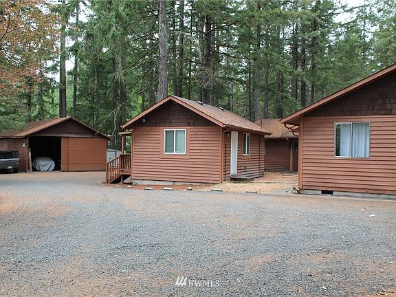 Wow!  This place has it all! The building on the right is the duplex, it's shaped like an "L". The little studio unit is in the center, and the big shop and 3-bay carport are in the back to the left. The 2-car garage for the duplex tenants is out of this shot to the right. 