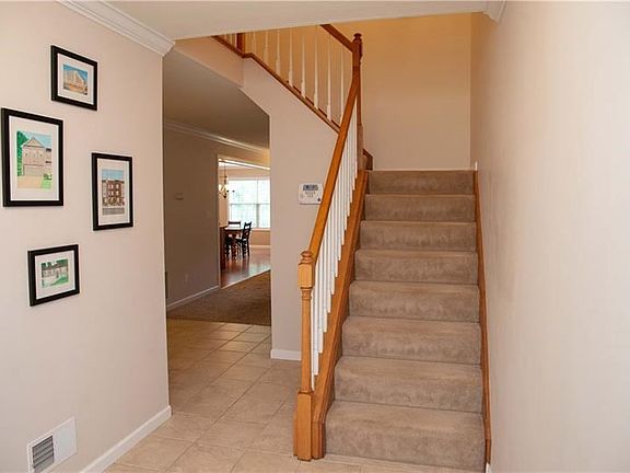 You will enter the tiled foyer and see an open stair-case that leads to the upper level.