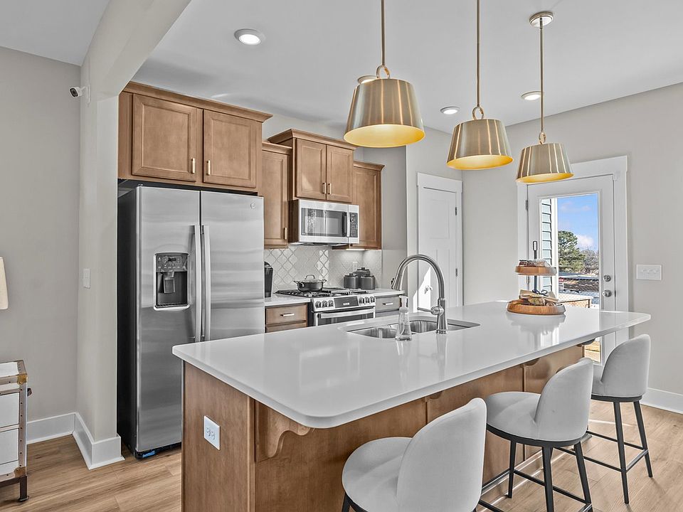 Exclusive DRB Homes kitchen with a center island, elevated finishes, and pendant lighting in a prime