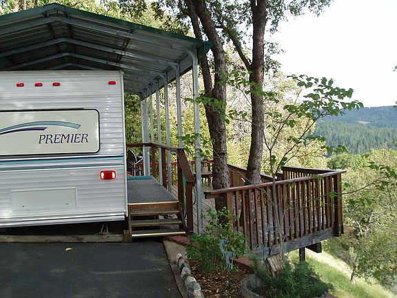 covered rv w/deck used as guest quarters. full hook-ups