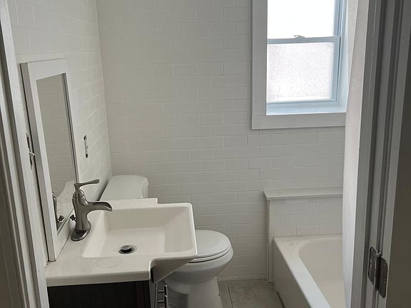 New full bathroom with pristine subway tile