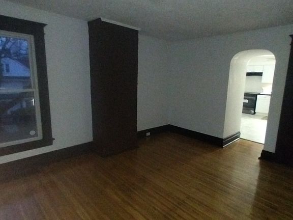 spacious living area with refinished original hardwood flooring and large closet for storage