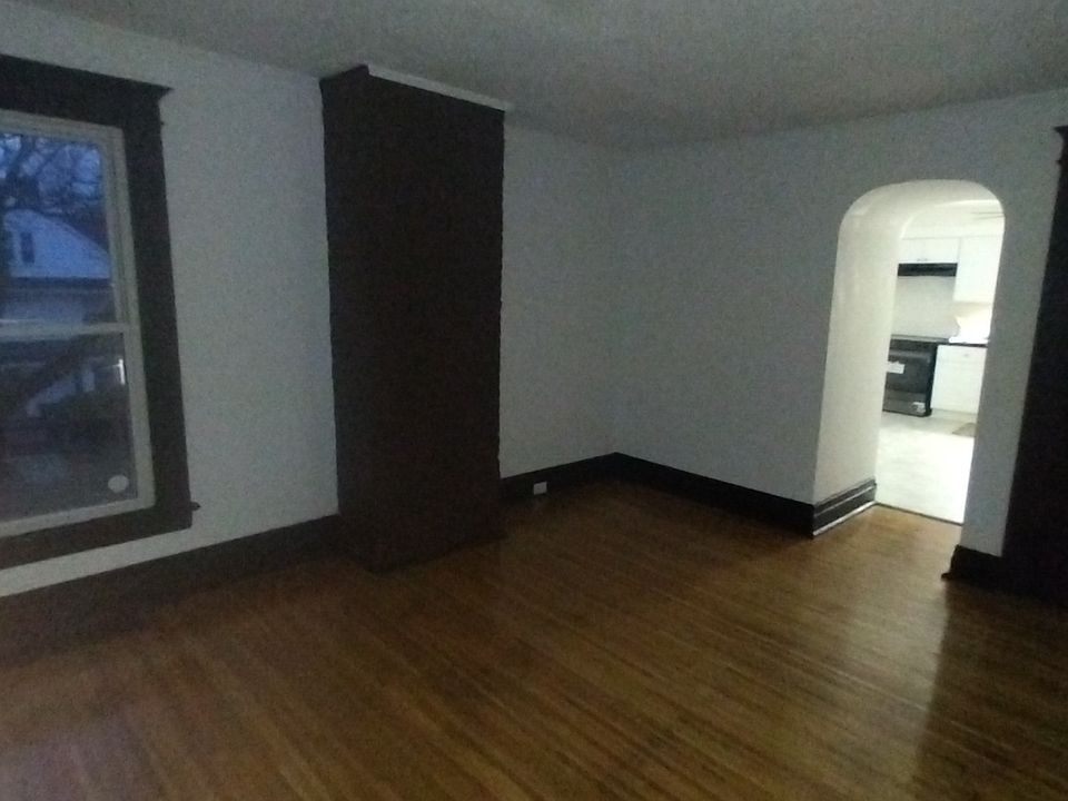 spacious living area with refinished original hardwood flooring and large closet for storage