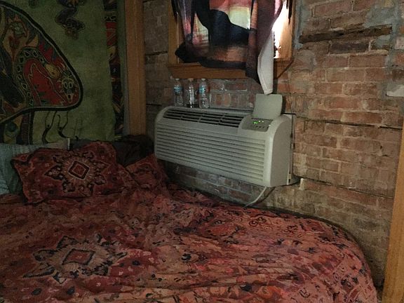 Bedroom with vintage Brick wall AC unit pictured has been removed and Central A/C has been installed.