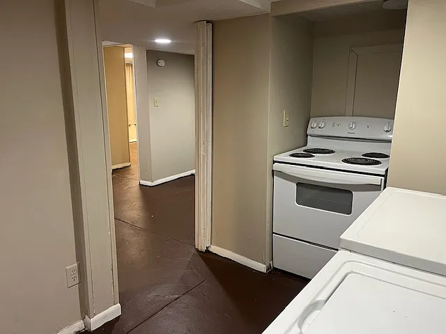 Kitchen (looking into common area). Electric stove and washer / dryer on the right.