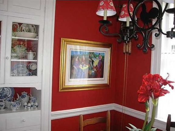Breakfast room boasts a built-in china cabinet, chair rail, and parquet floors