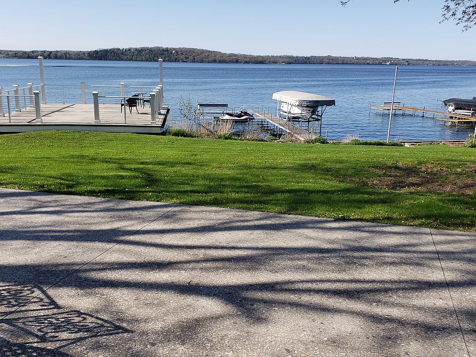 Roof of boathouse is concrete patio with railings and gas hookups.