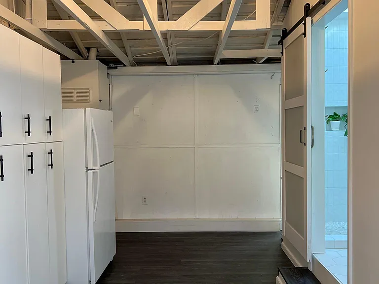 Bonus room with bathroom 2 on the right and new fridge and built-in cabinets for tons of storage on the left