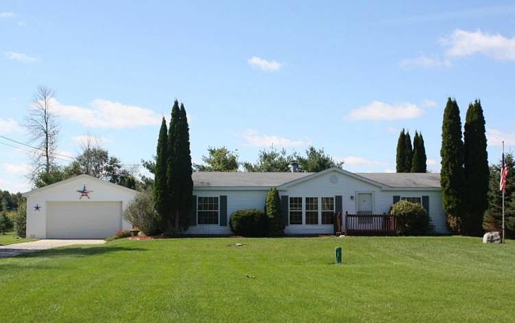 Sweet Country Setting with updated ranch on 2 acres, plus 4 car garage AND an extra 2 car garage/workshop! Spacious, open layout includes vaulted ceilings and stone gas fireplace in the living room. 3 Bedrooms with new carpet. 2 full baths with new corian countertops and skylights. Fresh paint and updated decor throughout. The kitchen features new counter tops and all appliances are included! Casual dining room with sliding doors to the large 3 season porch and picturesque country setting. Brand new Generac full house generator system included! Picturesque 2 acre setting with large garden spot and well maintained yard. Convenient to Midland, Freeland, and Saginaw. Must see to appreciate!