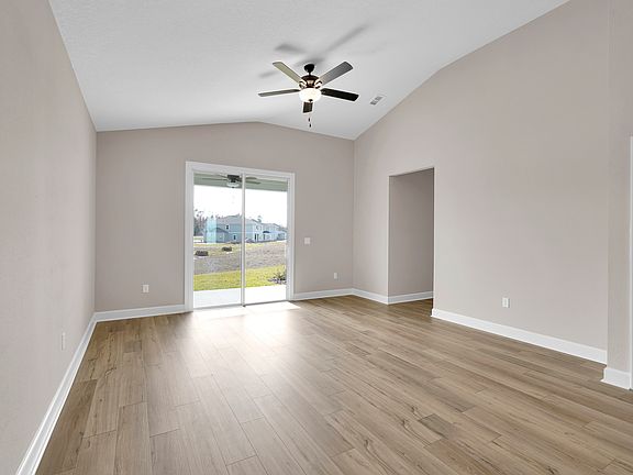 The living room features glass sliding doors, filling the space with natural light.