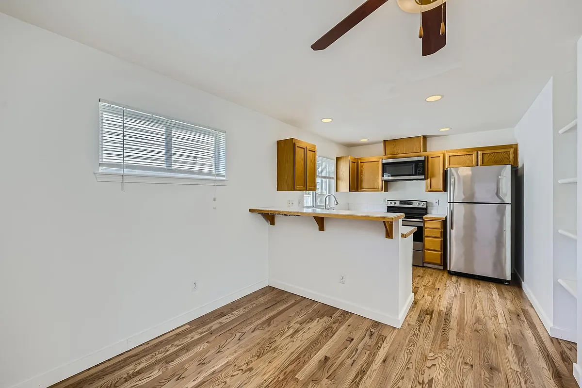Dining room and kitchen. Dining room has French doors that lead out to your private deck and yard. - 12711 35th Ave NE #B