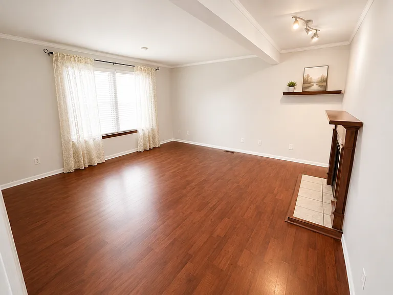 Living Room -
Bright and inviting living space featuring a cozy fireplace. Perfect for relaxing evenings or entertaining family and friends.