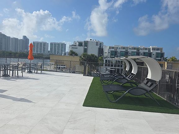 Lounge area on pool deck with turf
