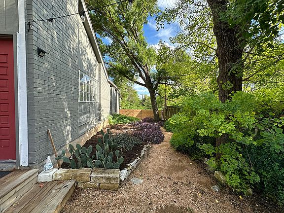 Side Yard leading to fully fenced backyard