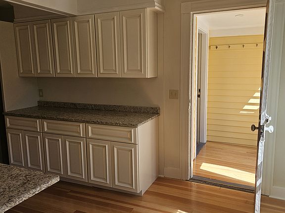 Kitchen leads to mud room one on side and dining area on the other