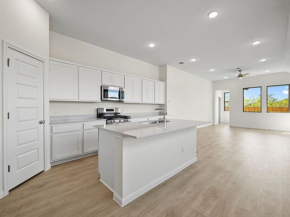Kitchen in the Cedar home plan by Trophy Signature Homes - REPRESENTATIVE PHOTO