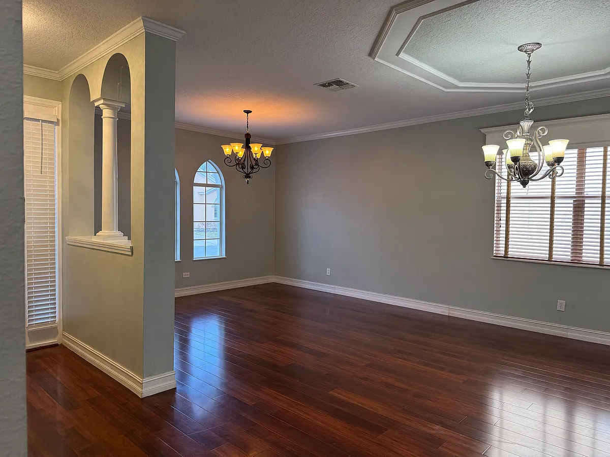 Bright and spacious living room featuring a modern open-concept layout, perfect for comfortable living and entertaining. - 11745 Via Lucerna Cir