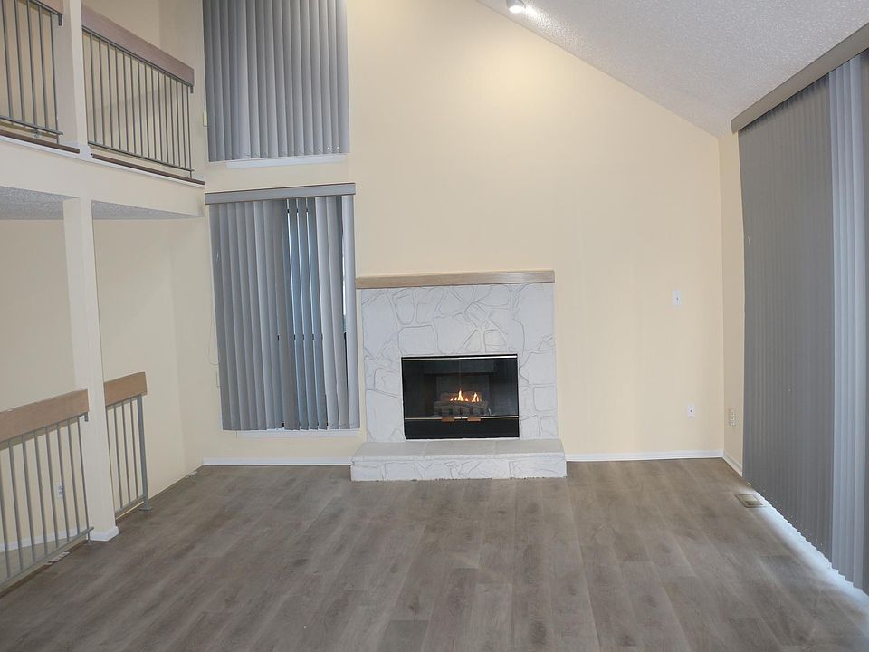Welcoming Living Room with gas fireplace and 2 patio doors , 2 sky lights provide ample light