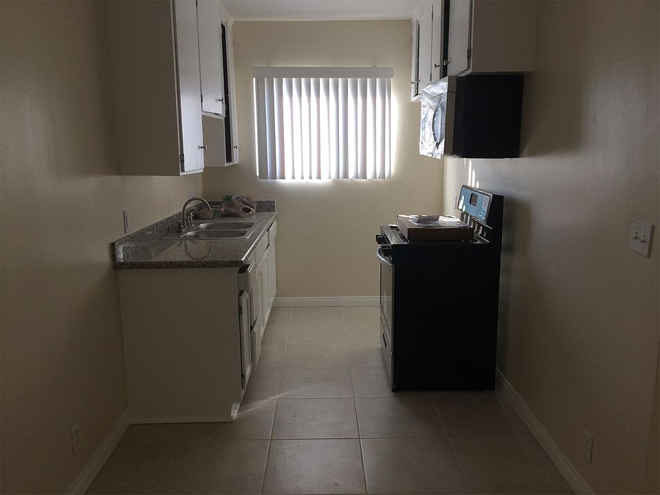 Kitchen with brand new stove, microwave, cabinets, and grani