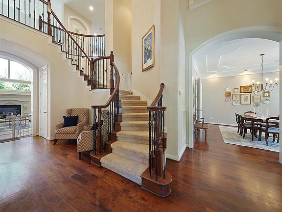 A two-story inviting entry greets you with the dining room and the living area in the background.