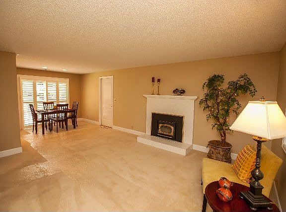 View from living room toward dining space. Don't miss the fireplace!