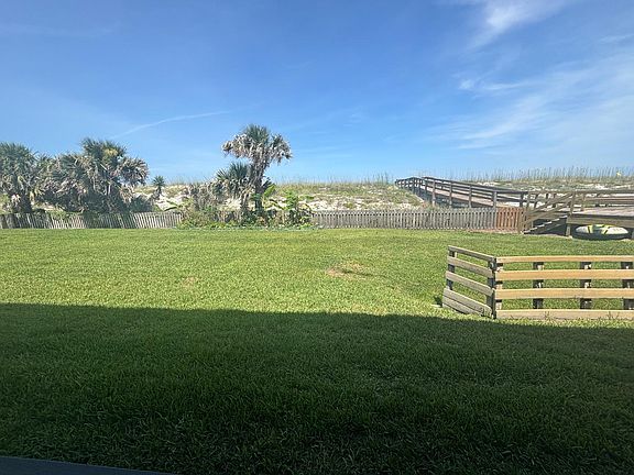 Beautiful fenced lawn area, adjacent to deck and beach walk-over. 100 feet to the sand & ocean!