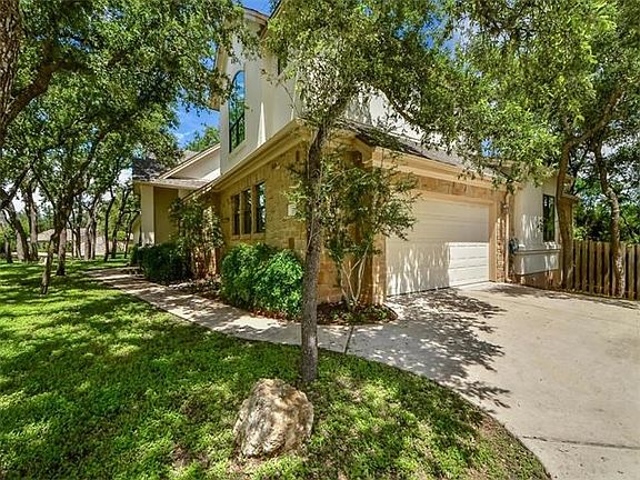 Private garage entrance from the side with ample guest parking.