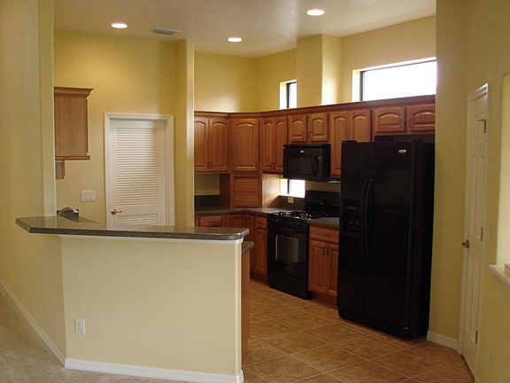 Kitchen w/oak cabinets and corian countertops