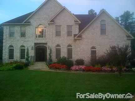 beautiful landscaping with fenced yard and sprinkler system security system
